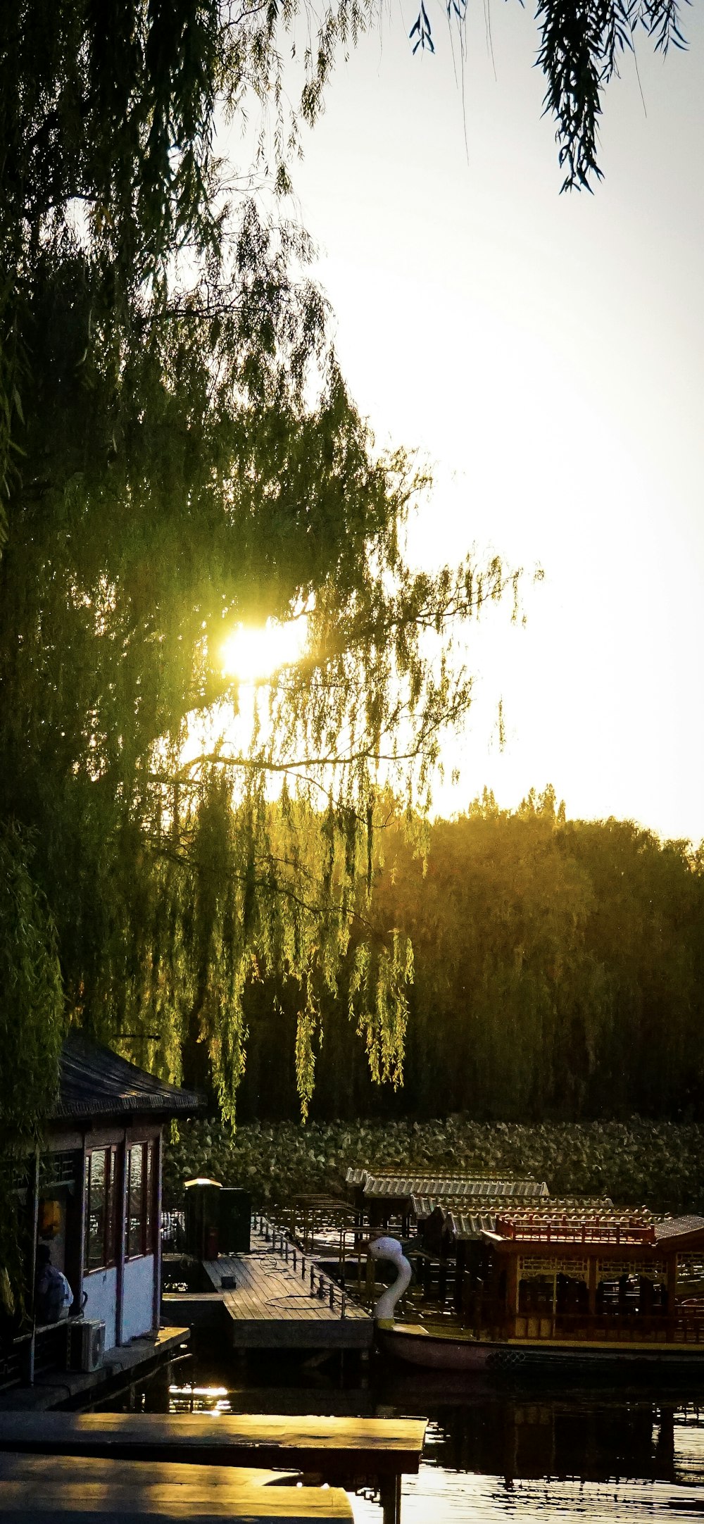 the sun is setting over a boat dock