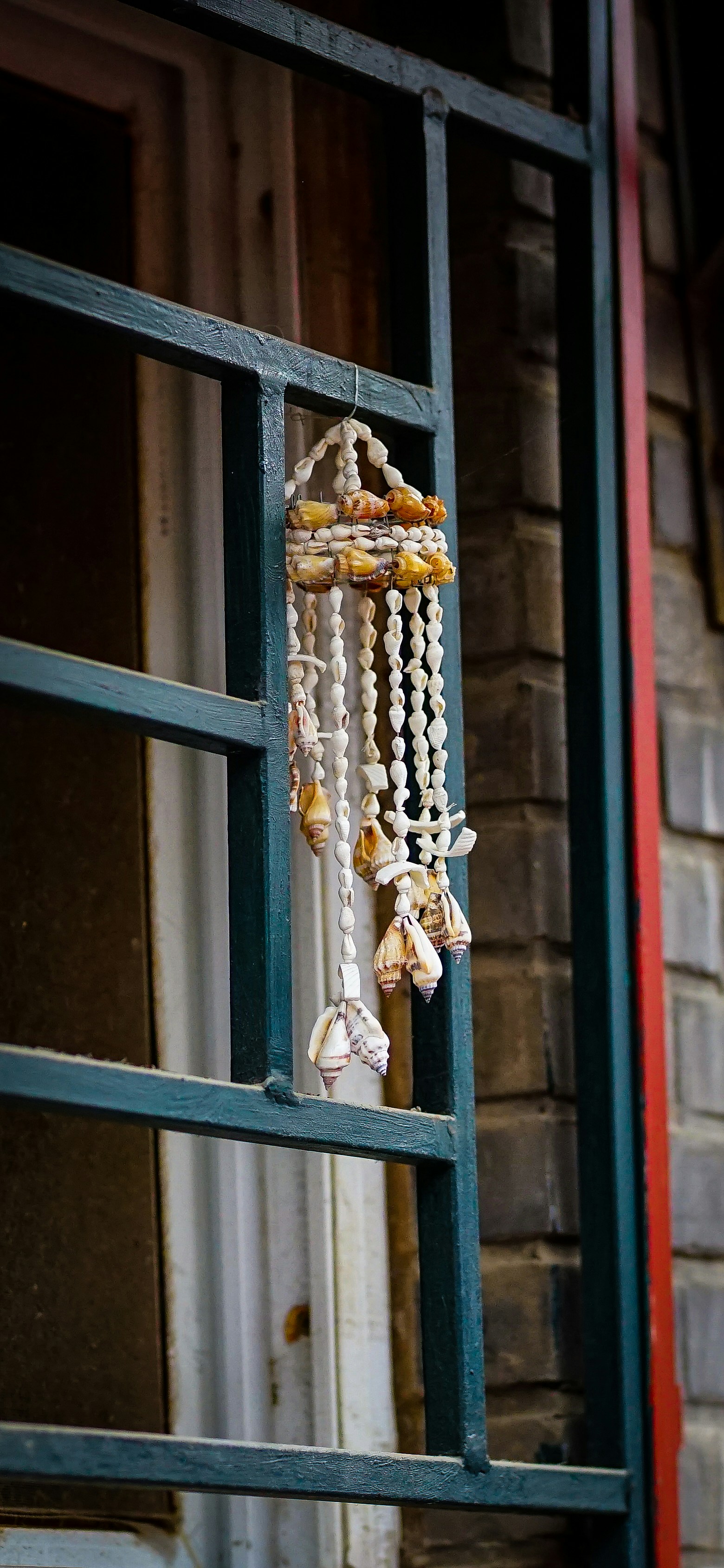 a window with a bunch of beads hanging from it