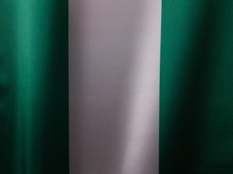 a close up of a green and white curtain