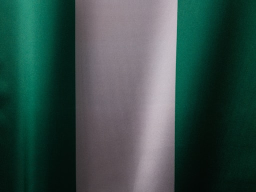 a close up of a green and white curtain