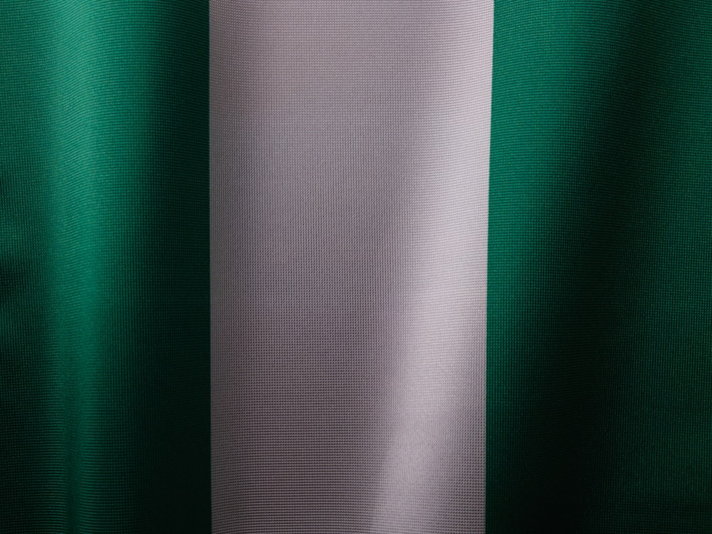 a close up of a green and white curtain