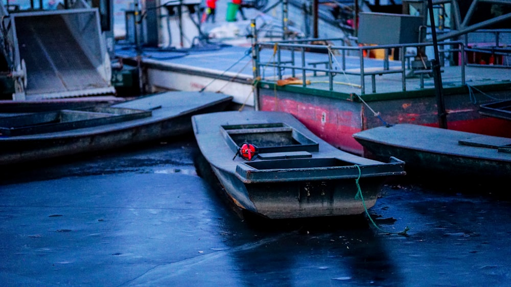 a row of boats sitting next to each other on a body of water