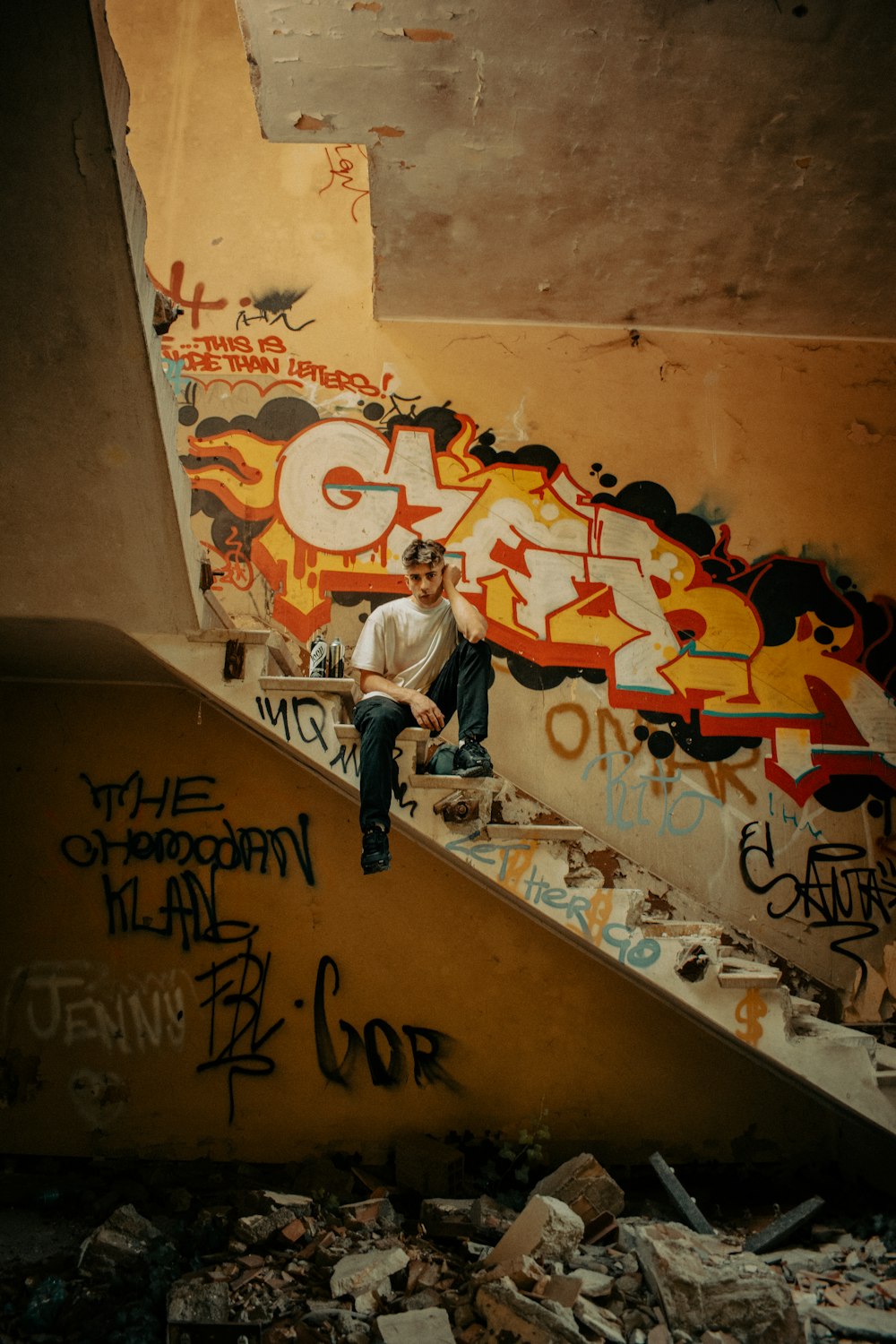 a man sitting on the bottom of a stair case