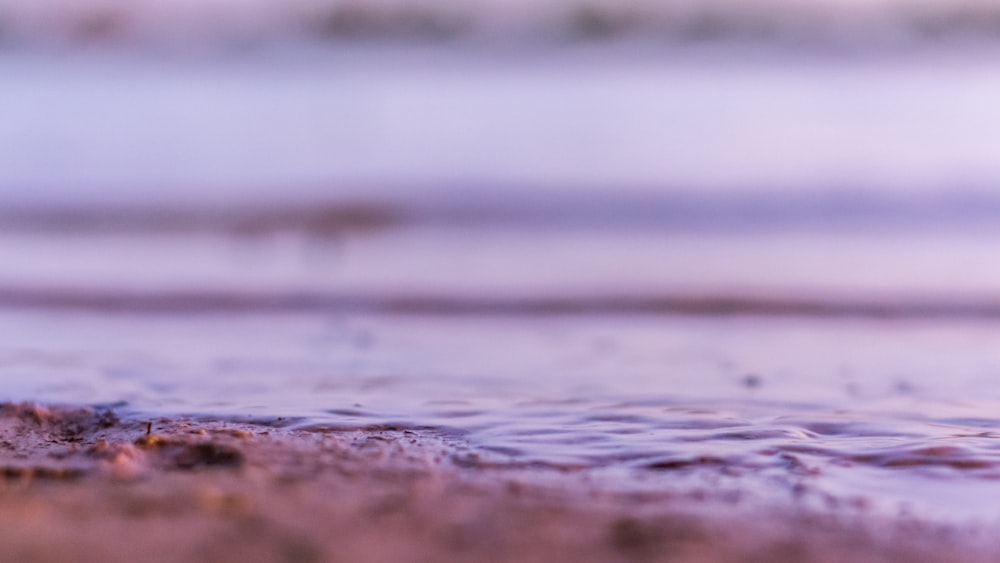 a blurry photo of a beach with water and sand