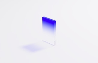 a blue and white square shaped object on a white surface