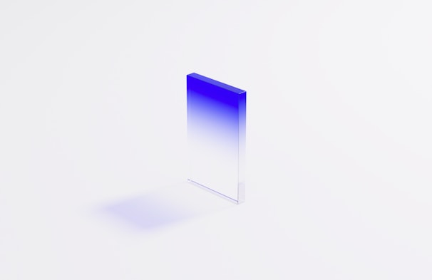 Close-up of a perfectly crafted glass block reflecting soft blue light.
