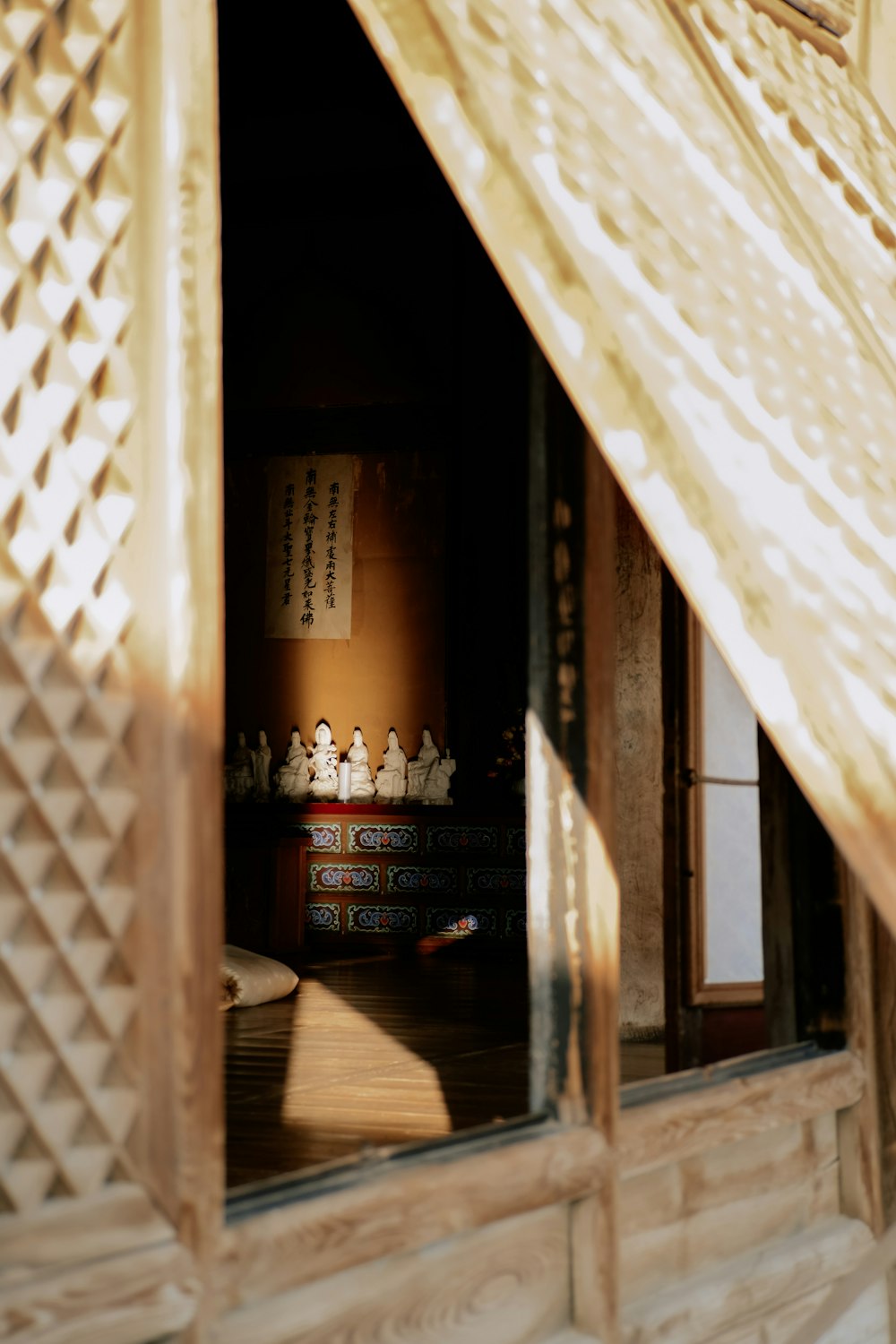 an open window with a small statue in the window