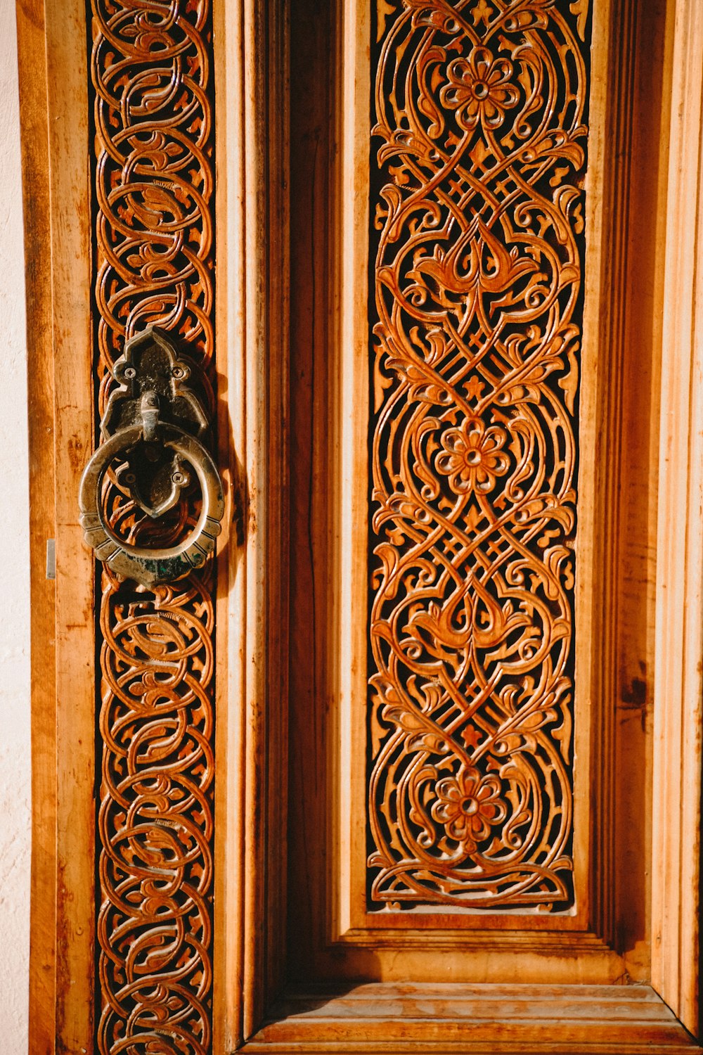 a close up of a wooden door with a metal handle