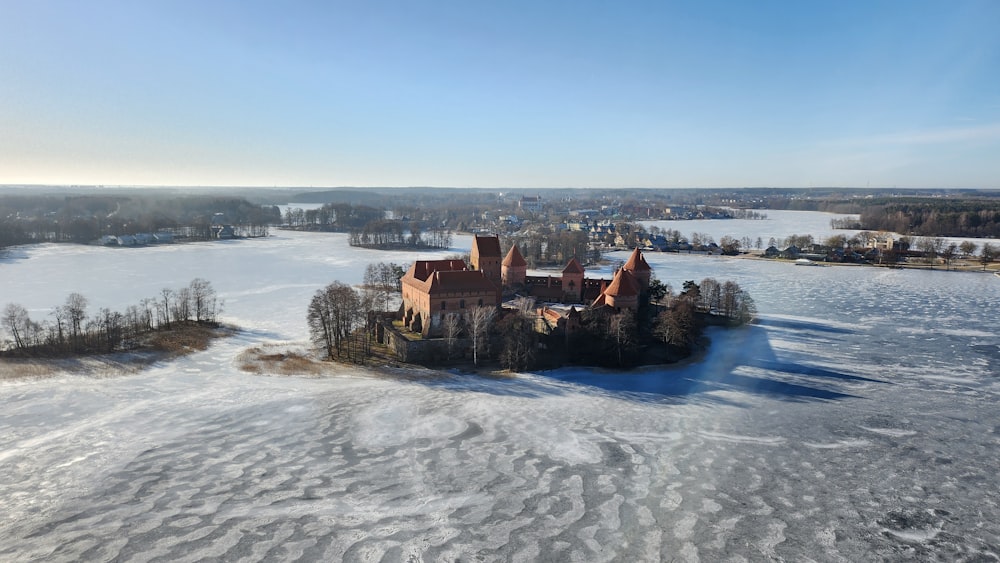 an aerial view of a castle in the middle of a frozen lake