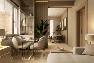 Open-plan dining area with soft neutral walls and greenery.