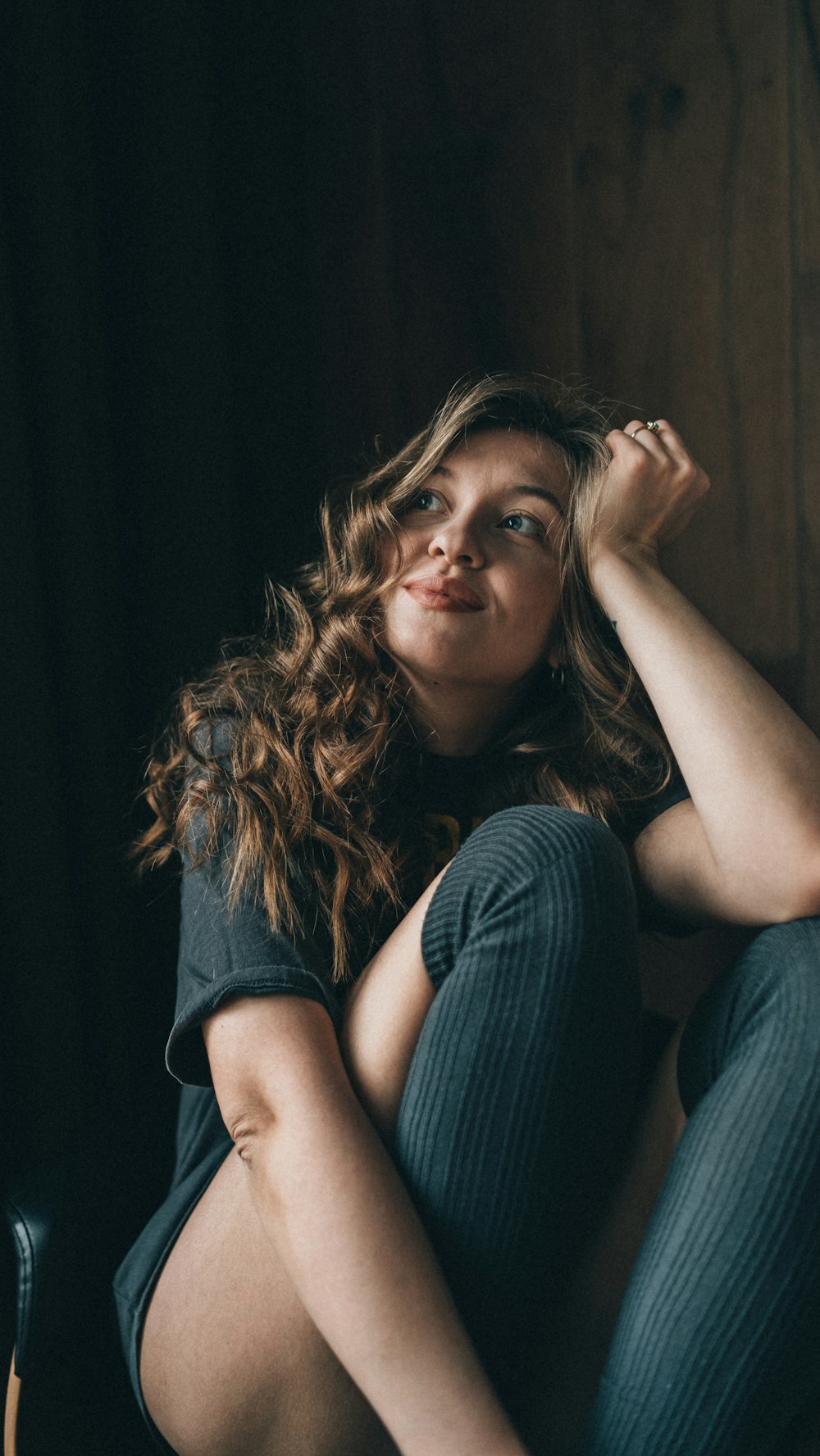 a woman sitting on a chair with her legs crossed