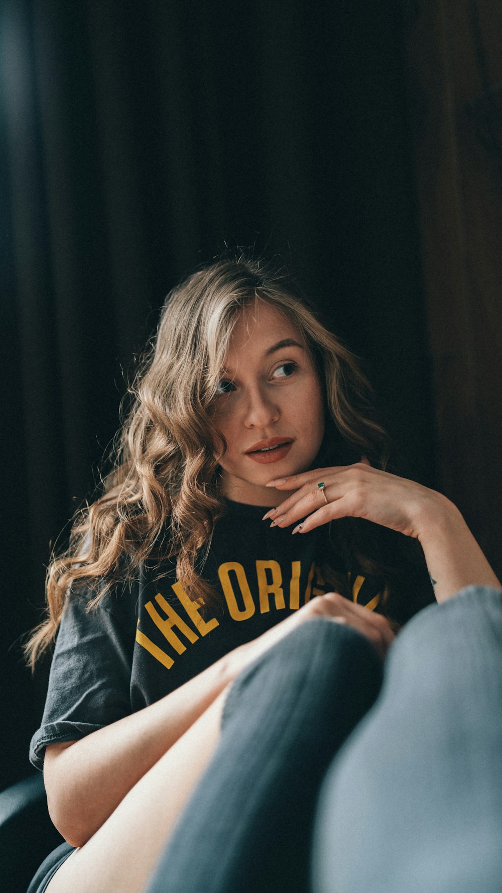 a woman sitting on a couch with her legs crossed