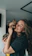 A joyful woman gently hugging her golden retriever in a softly lit, elegant room.