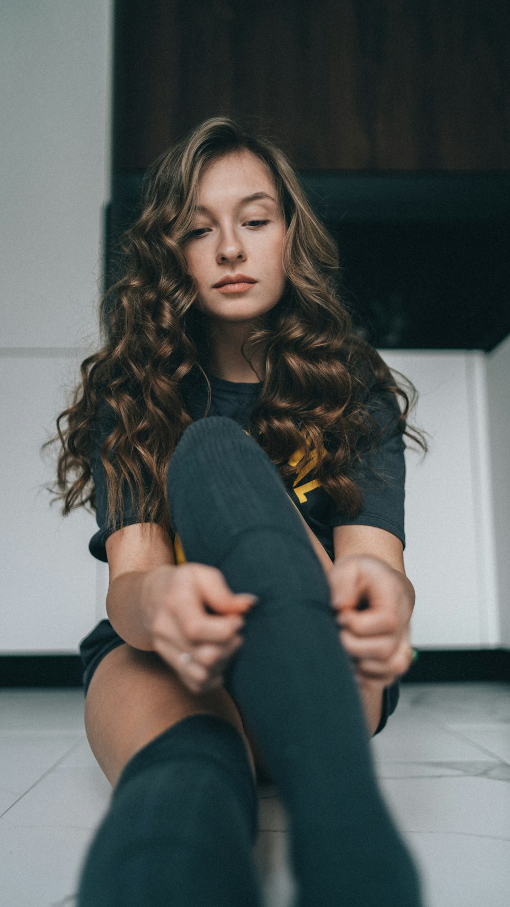 a woman sitting on the floor with her legs crossed