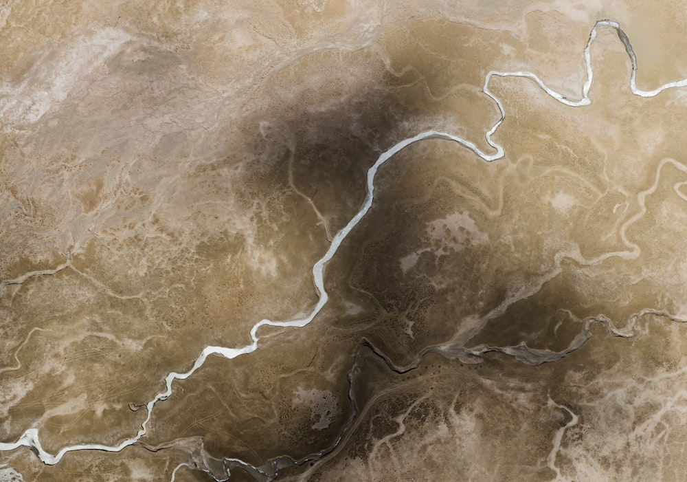 an aerial view of a river running through a desert