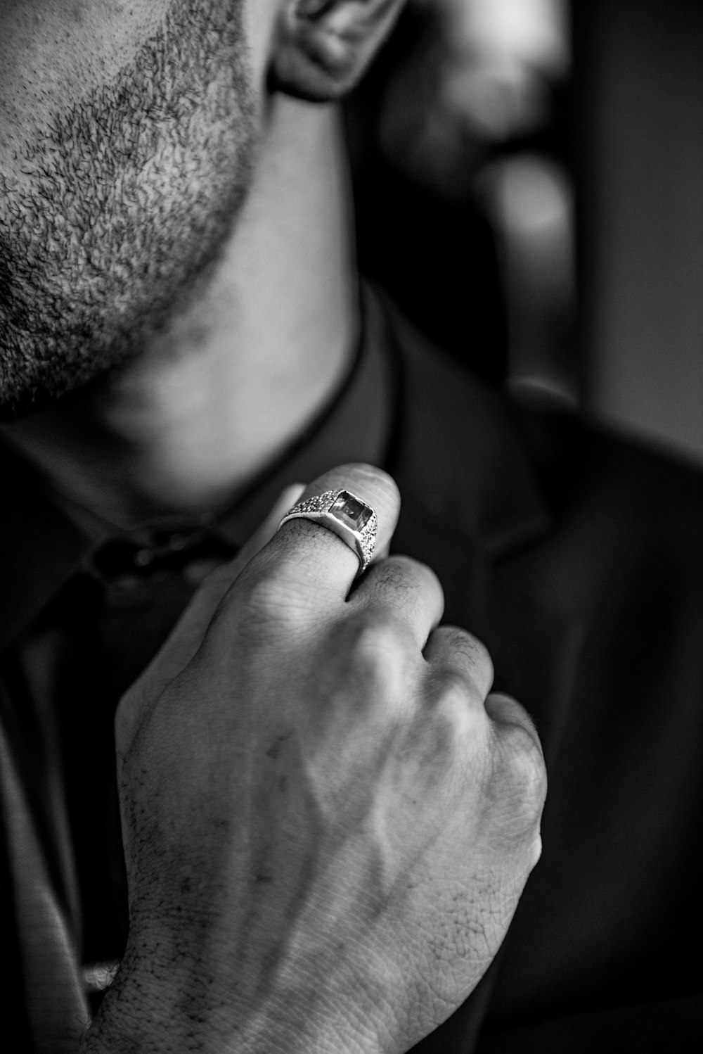 a man wearing a ring and a bow tie