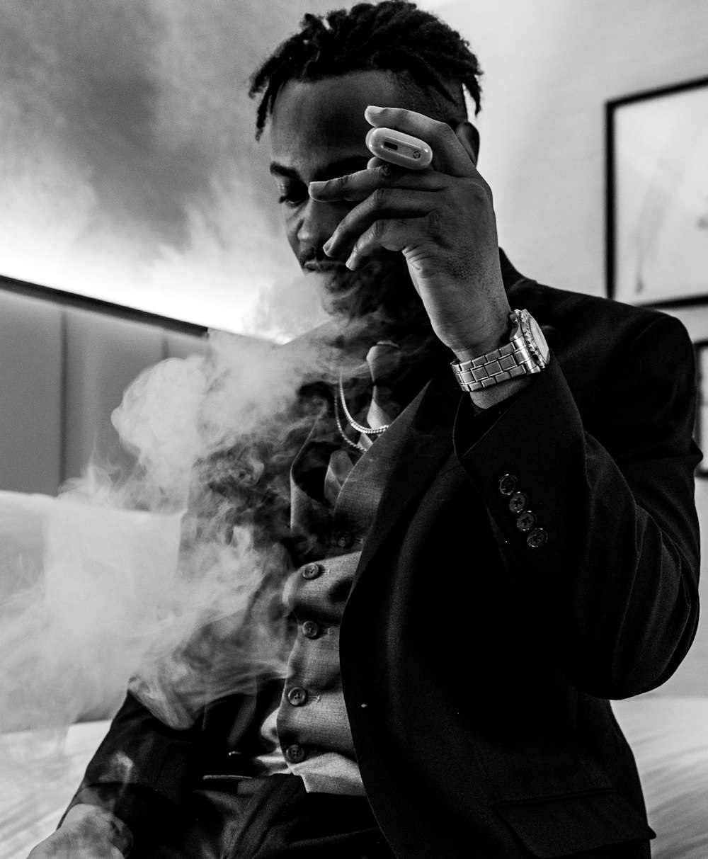 a man in a suit smoking a cigarette