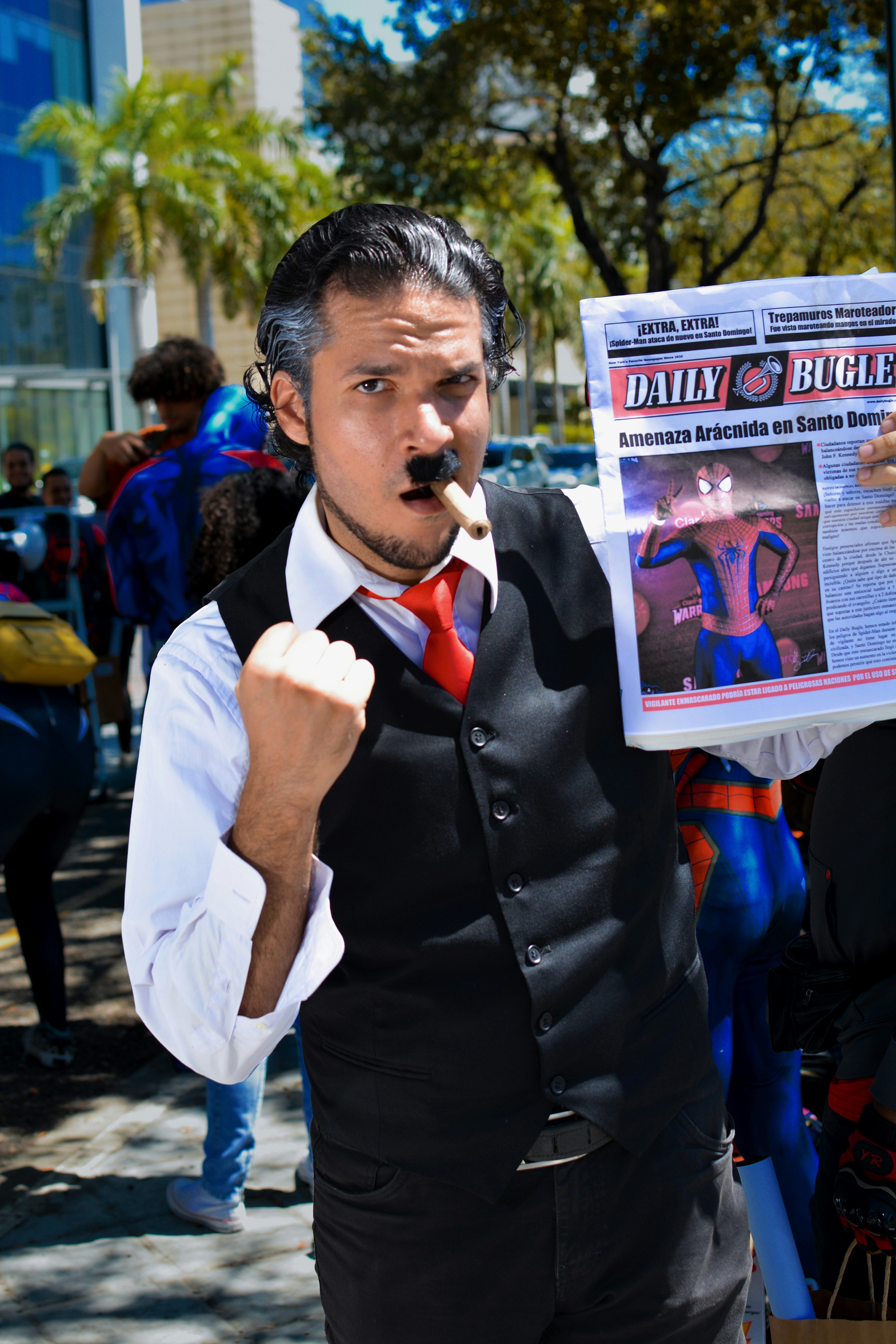 a man in a vest and tie holding a newspaper