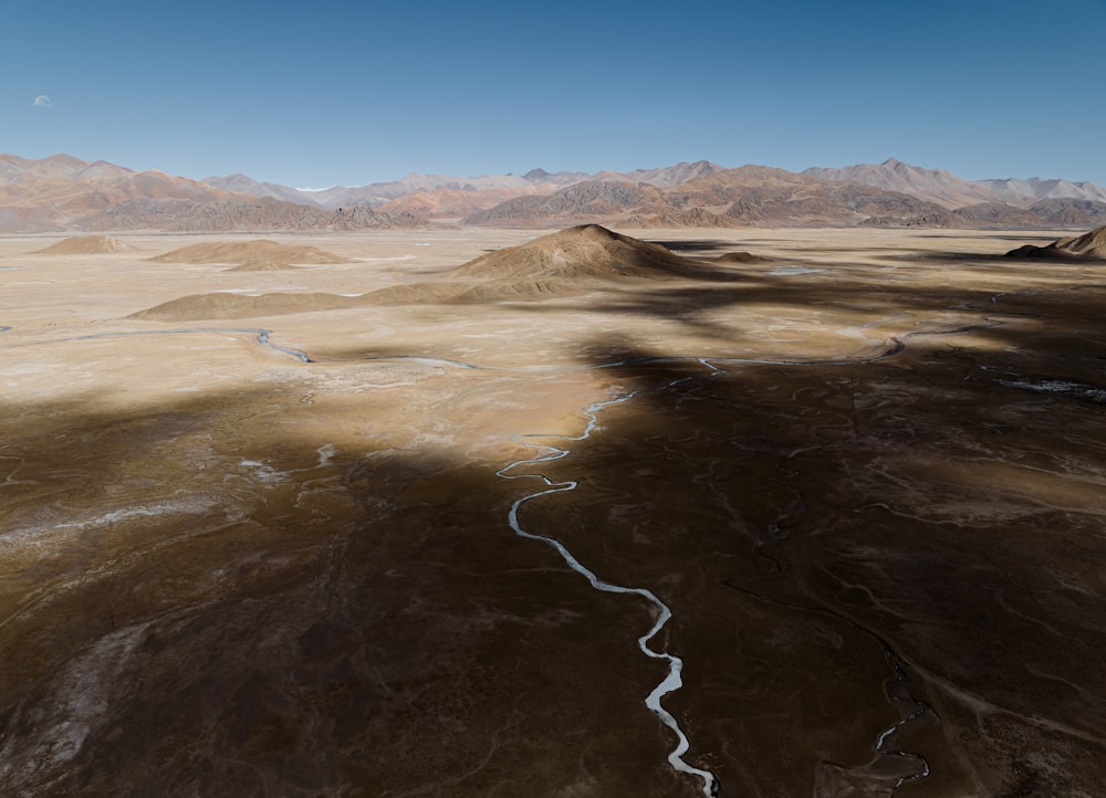 an aerial view of a river running through a desert