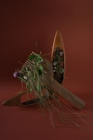 Various wooden combs arranged artistically on a rustic wooden table with sunlight filtering through.