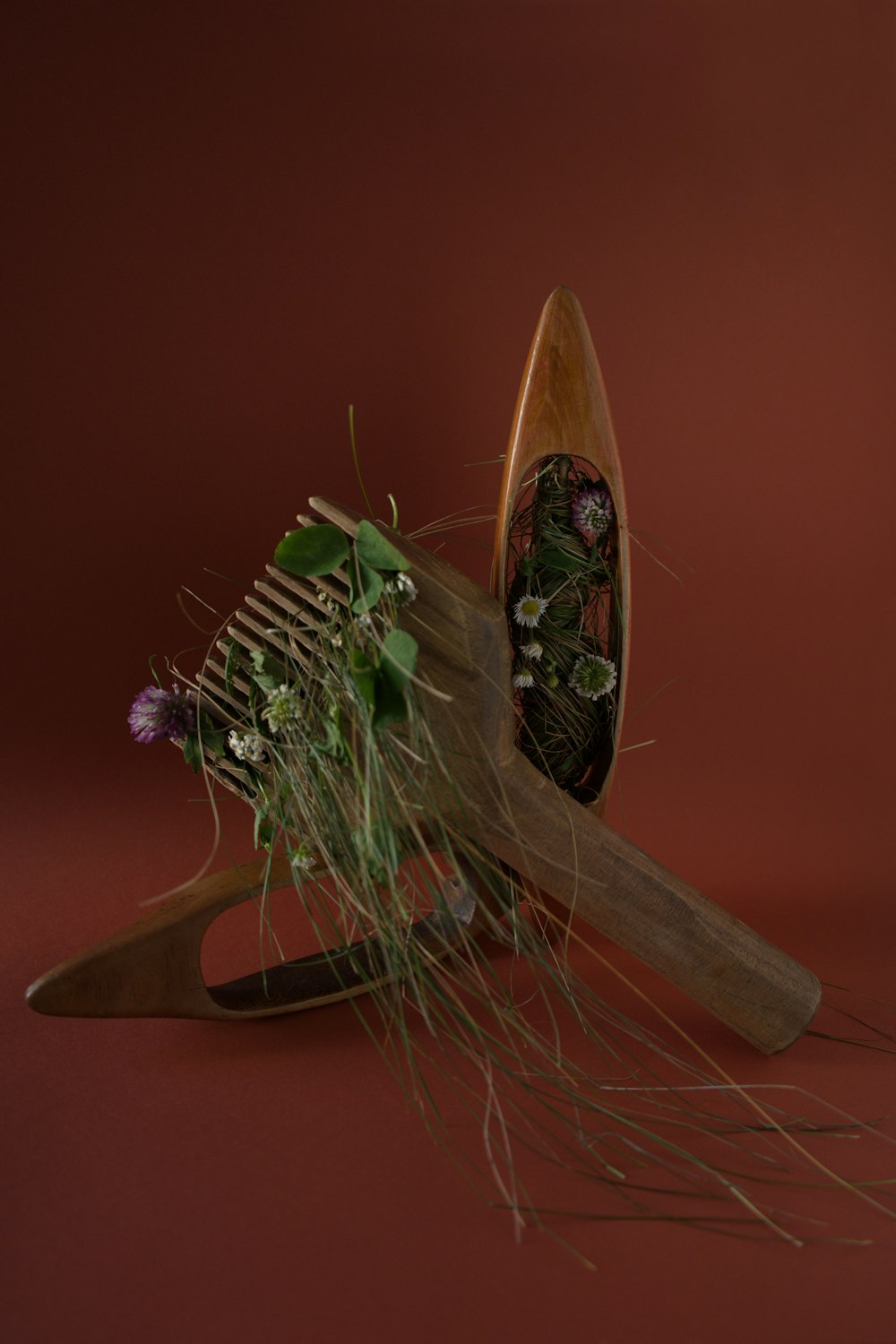 a wooden comb with flowers inside of it