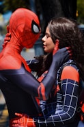 Sensual scene of two superheroes sharing a charged moment on a rooftop.
