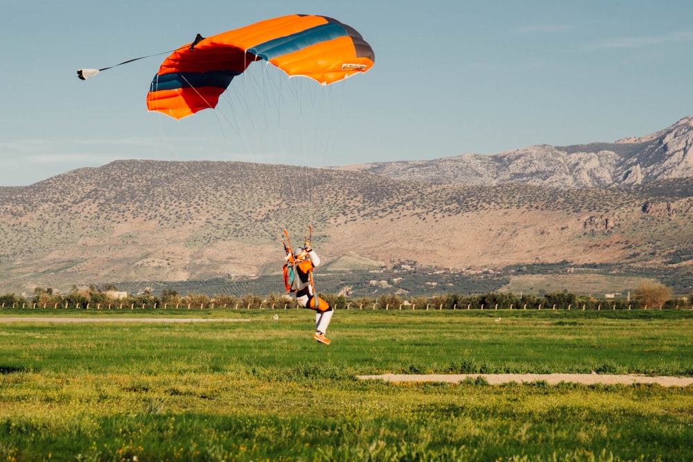 a person is flying a kite in a field