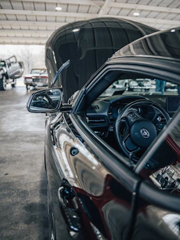A close-up shot of a mechanic testing a body control module inside a car in a Stevenage garage.