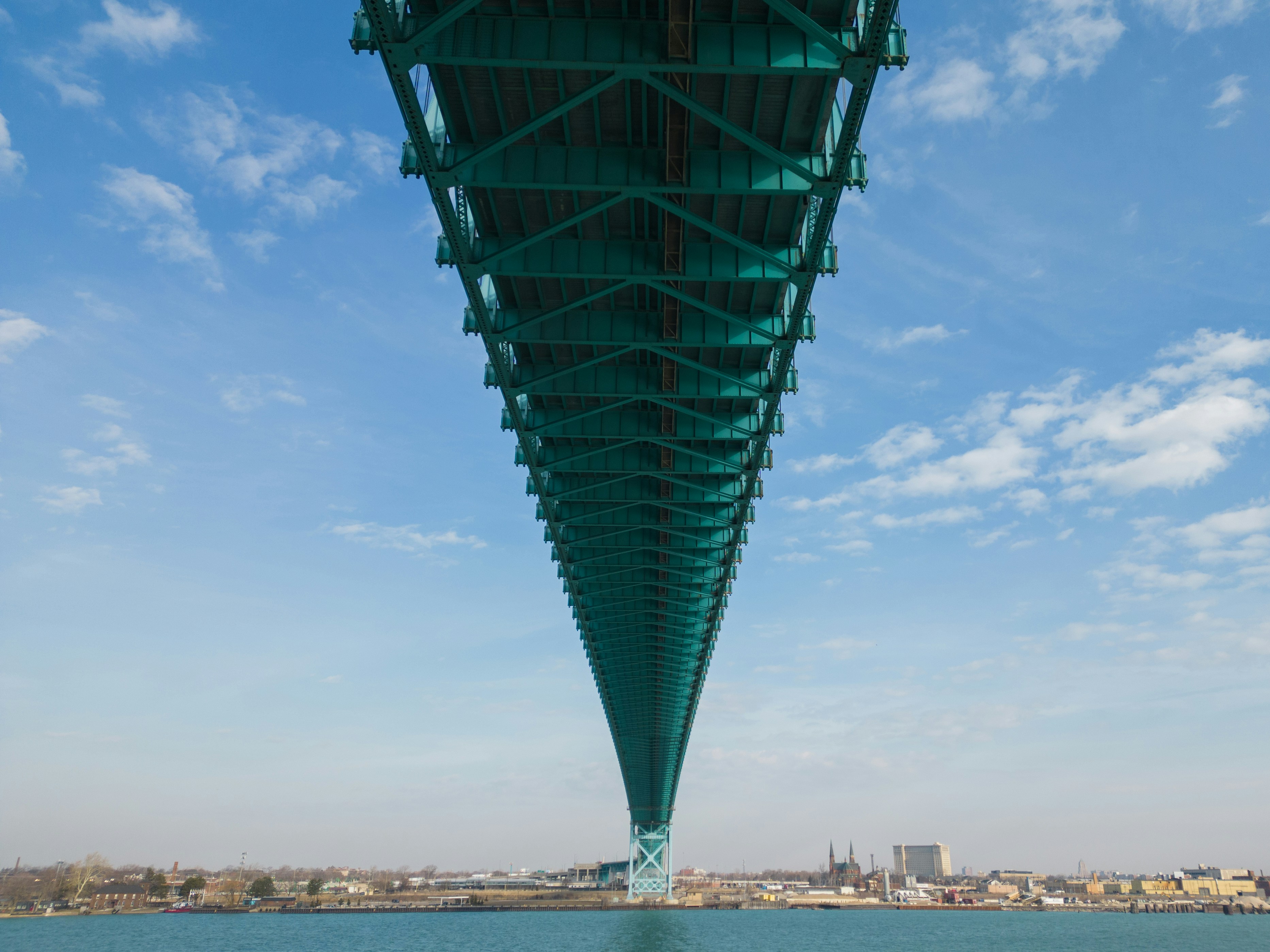 the underside of a bridge over a body of water