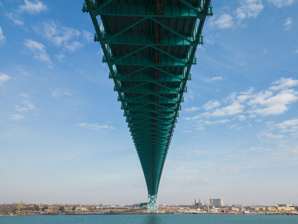 the underside of a bridge over a body of water