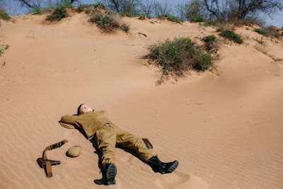 Sturdy military helmet resting on desert sand