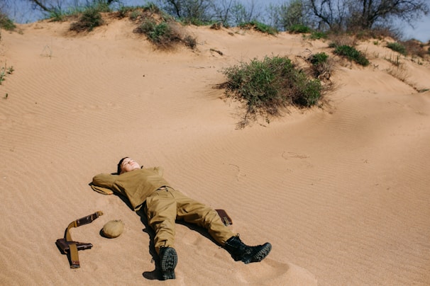Tactical t-shirt laid out on sandy terrain with a backdrop of Australian outback.