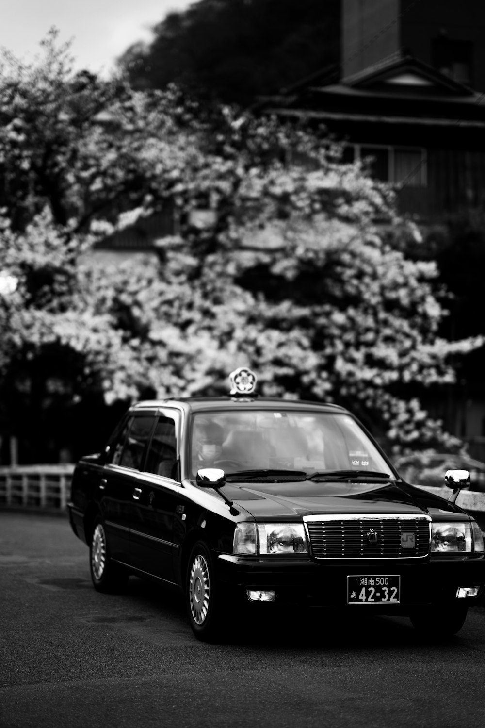 a black and white photo of a taxi cab