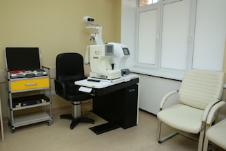a room with a microscope and a chair