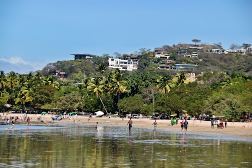 A vibrant tropical beach scene with smiling families and couples enjoying their vacation.