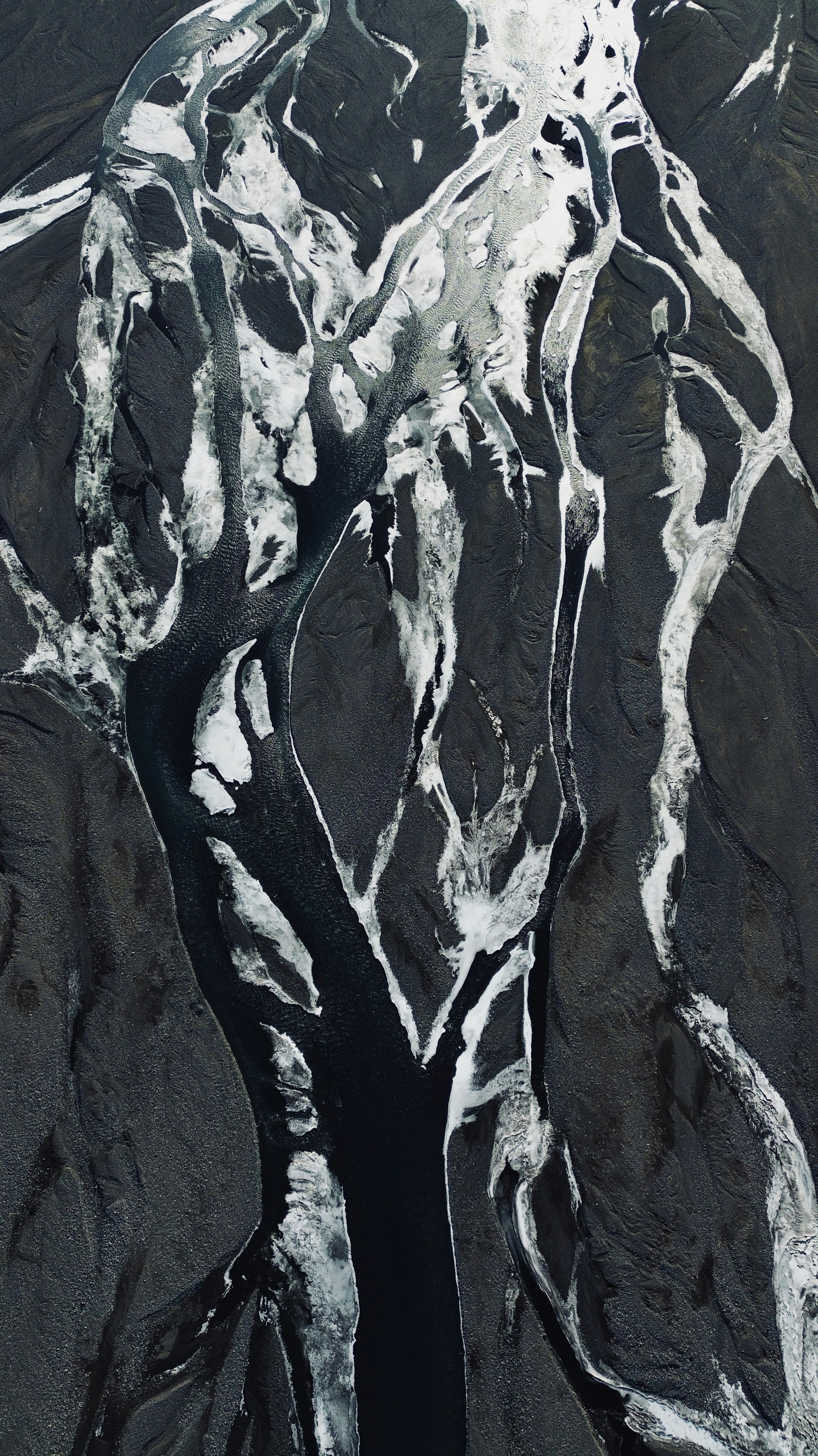 an aerial view of a river and mountains