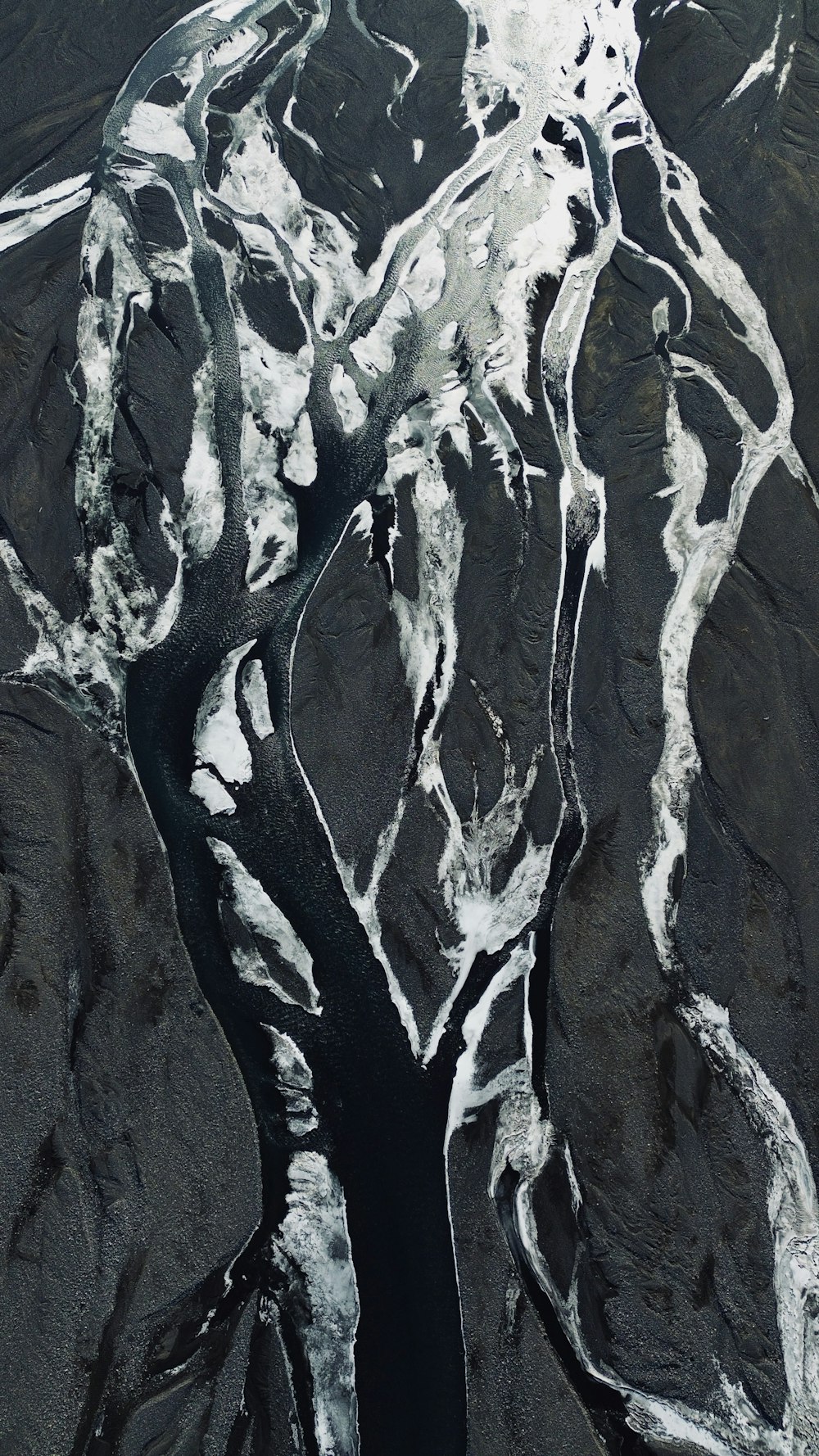 an aerial view of a river and mountains