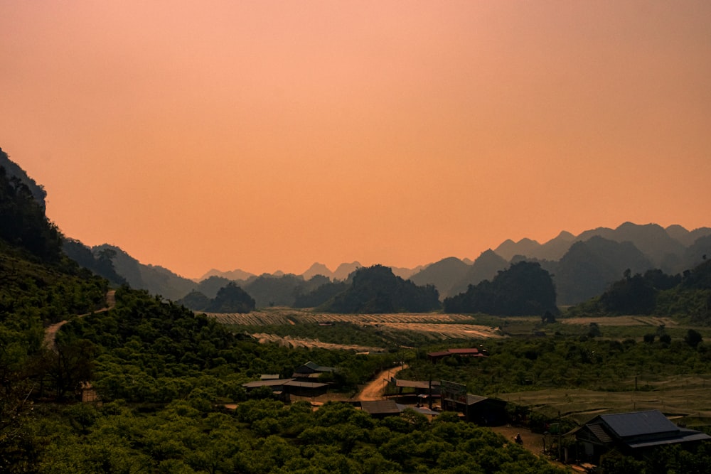 a scenic view of a mountain range with houses on it