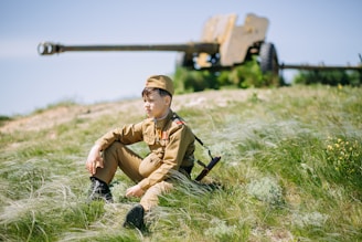 A veteran in uniform inspecting a septic system on a sunny day in Florence.
