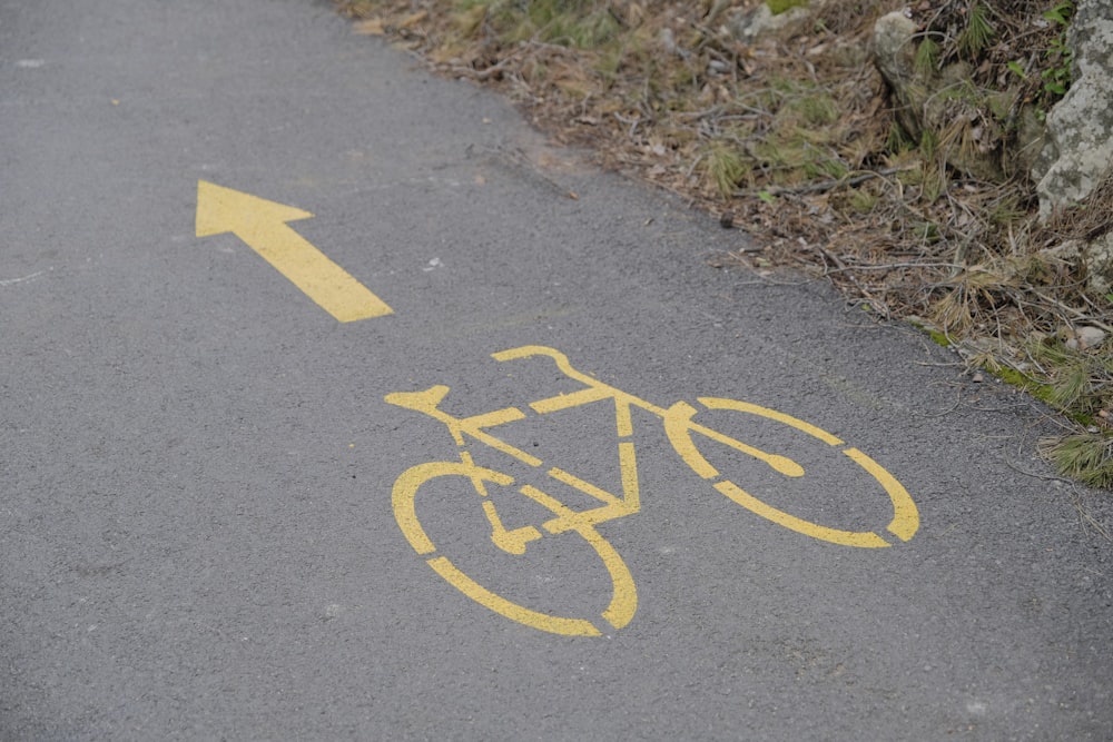 a bike lane with a yellow arrow painted on it