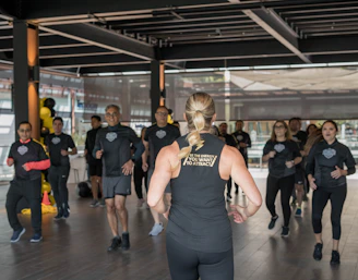 A group training session with an expert trainer guiding members through intense exercises.