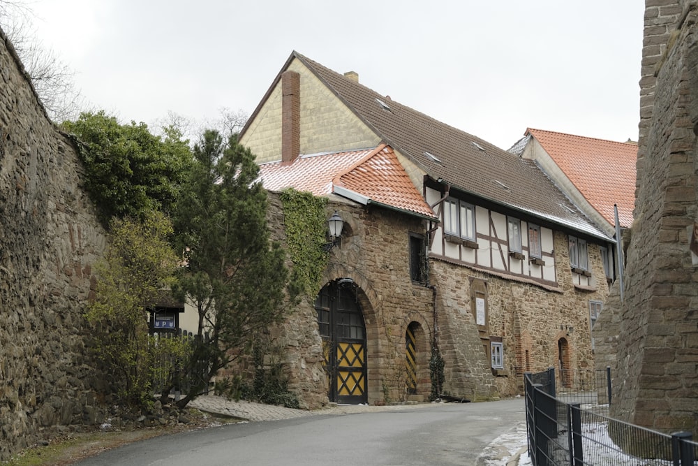 a stone building with a red tiled roof