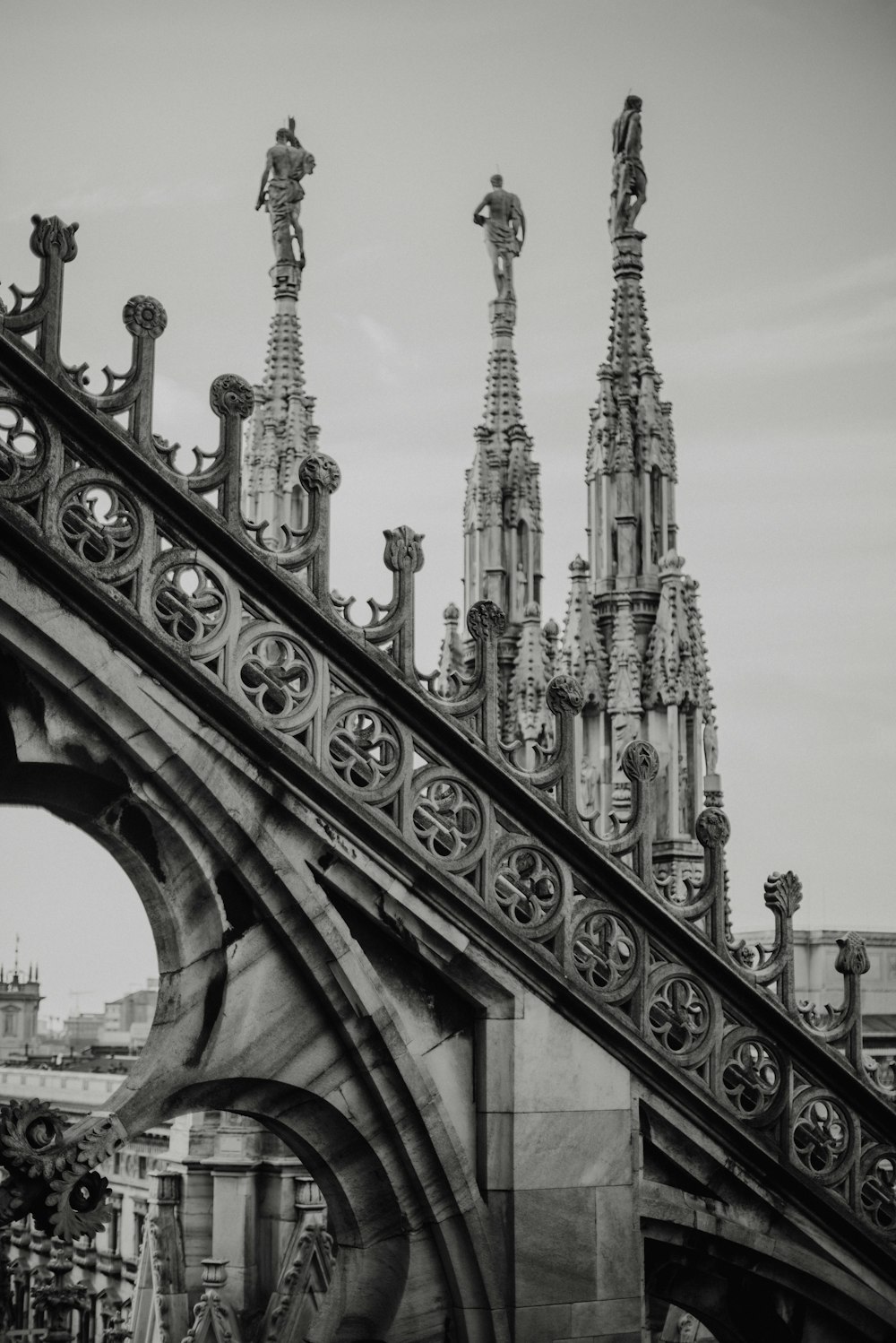 a black and white photo of a bridge with ornate architecture