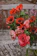 A vibrant bouquet of mixed flowers arranged beautifully in a rustic vase.