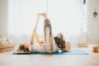 a woman doing a yoga pose on a yoga mat