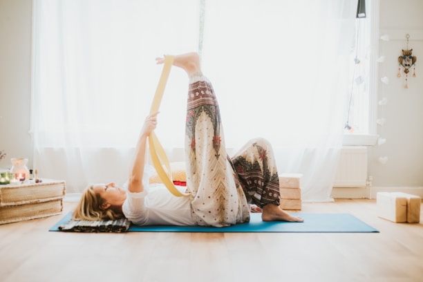 a woman doing a yoga pose on a yoga mat