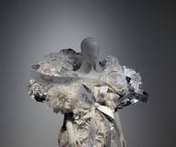 A close-up of a vibrant floral frock displayed on a mannequin.