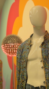 A vibrant printed shirt displayed on a mannequin in a bright studio.