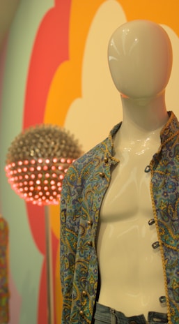 A vibrant t-shirt design displayed on a mannequin against a colorful backdrop.