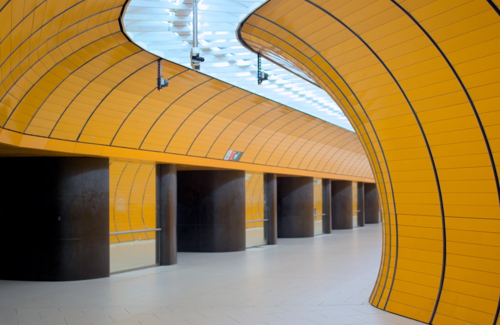 a yellow and black building with lots of doors